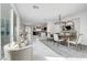 Bright dining room with white marble floors, modern chandelier, and stylish chairs at 4499 Amazing View St, Las Vegas, NV 89129