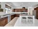 Modern kitchen with an island, stainless steel appliances, granite countertops, and ample cabinet space at 4499 Amazing View St, Las Vegas, NV 89129