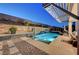 Inviting backyard pool with cascading waterfall, spa, and sunbathing chairs at 4499 Amazing View St, Las Vegas, NV 89129