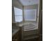 Bathroom with corner bathtub and window at 5018 Rio Linda Cir, North Las Vegas, NV 89031