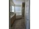 Relaxing bathroom with soaking tub, shower, and updated tile floors at 5018 Rio Linda Cir, North Las Vegas, NV 89031