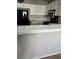 White kitchen cabinets, tile countertops, and microwave at 5018 Rio Linda Cir, North Las Vegas, NV 89031