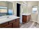 Elegant bathroom features double sinks, a large mirror, and updated flooring at 5249 Fiery Sky Ridge St, Las Vegas, NV 89148