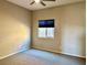 Bright bedroom featuring a window with a blue shade and neutral carpeting at 5249 Fiery Sky Ridge St, Las Vegas, NV 89148