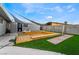 Large backyard deck with shade sail and artificial turf at 5509 Evergreen Ave, Las Vegas, NV 89107