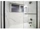 Updated bathroom featuring a shower with glass enclosure and marble tile at 5509 Evergreen Ave, Las Vegas, NV 89107