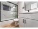 Modern bathroom with white vanity, marble shower, and black accents at 5509 Evergreen Ave, Las Vegas, NV 89107