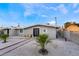 Updated single story home with modern front door and gravel yard at 5509 Evergreen Ave, Las Vegas, NV 89107