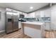 Modern kitchen with white cabinets, stainless steel appliances, and quartz countertops at 5509 Evergreen Ave, Las Vegas, NV 89107