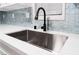 Modern kitchen sink with a sleek black faucet and white quartz countertops at 5509 Evergreen Ave, Las Vegas, NV 89107