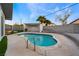 Refreshing kidney-shaped pool with a pergola and landscaping at 5509 Evergreen Ave, Las Vegas, NV 89107