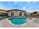 Kidney shaped pool with concrete decking at 5509 Evergreen Ave, Las Vegas, NV 89107