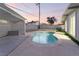 Enjoy this kidney-shaped pool with pergola and spacious backyard at 5509 Evergreen Ave, Las Vegas, NV 89107