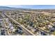 A beautiful aerial view shows a home in a well-maintained residential community with tree-lined streets at 6005 Blowing Bellows St, Las Vegas, NV 89130