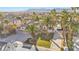 Aerial view of a large house with mature palm trees in the front yard and solar panels on the roof at 6005 Blowing Bellows St, Las Vegas, NV 89130