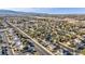 A beautiful aerial view shows a well-maintained residential community with tree-lined streets at 6005 Blowing Bellows St, Las Vegas, NV 89130