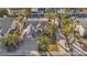 Overhead view of a house with a three-car garage, a pool, lots of palm trees, and solar panels on the roof at 6005 Blowing Bellows St, Las Vegas, NV 89130