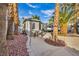 Palm tree lined backyard with a guest house, outdoor seating area, and RV trailer at 6005 Blowing Bellows St, Las Vegas, NV 89130