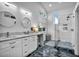 Stylish bathroom featuring dual sinks, marble countertops, modern lighting, and a glass-enclosed shower at 6005 Blowing Bellows St, Las Vegas, NV 89130