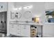 Elegant bathroom featuring dual sinks, marble countertops, modern lighting, and a bright window at 6005 Blowing Bellows St, Las Vegas, NV 89130