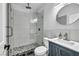 Modern bathroom featuring a glass enclosed shower with decorative tile and a vessel sink with a navy blue cabinet at 6005 Blowing Bellows St, Las Vegas, NV 89130