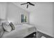 Neutral bedroom with black ceiling fan, hardwood floors, a queen bed, and a window with plantation shutters at 6005 Blowing Bellows St, Las Vegas, NV 89130