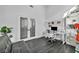 Well-lit bedroom with glass paneled doors, sleek gray futon and desk, ideal for a modern home office at 6005 Blowing Bellows St, Las Vegas, NV 89130