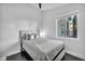 Bright bedroom with dark hardwood floors, white walls, a queen bed, and a window with plantation shutters at 6005 Blowing Bellows St, Las Vegas, NV 89130