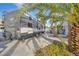 Long RV driveway with a newer model Jayco trailer parked in front of palm trees at 6005 Blowing Bellows St, Las Vegas, NV 89130