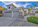 Charming single-story home featuring a three-car garage, desert landscaping and stone accents at 6005 Blowing Bellows St, Las Vegas, NV 89130