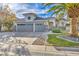 Charming single-story home featuring a three-car garage, desert landscaping and stone accents at 6005 Blowing Bellows St, Las Vegas, NV 89130