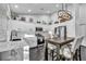 Beautiful white kitchen with stainless steel appliances, marble countertops, and an eat-in island at 6005 Blowing Bellows St, Las Vegas, NV 89130