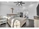 Comfortable main bedroom featuring a ceiling fan, hardwood floors, and abundant natural light at 6005 Blowing Bellows St, Las Vegas, NV 89130