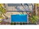 Aerial view of a backyard pool surrounded by lush landscaping, palm trees, and patio furniture at 6005 Blowing Bellows St, Las Vegas, NV 89130