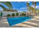 Inviting swimming pool with clear blue water and a tiled border, surrounded by palm trees at 6005 Blowing Bellows St, Las Vegas, NV 89130