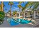 Lush backyard featuring a sparkling pool, relaxing patio, and mature palm trees at 6005 Blowing Bellows St, Las Vegas, NV 89130