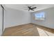 Bright bedroom with a ceiling fan and two windows, one covered and one offering neighborhood views at 6027 Stone Hollow Ave, Las Vegas, NV 89156