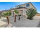 A two-story house with desert landscaping, an attached two-car garage, and a concrete driveway at 6027 Stone Hollow Ave, Las Vegas, NV 89156