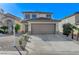 Charming two-story home featuring a two-car garage and low-maintenance desert landscaping at 6027 Stone Hollow Ave, Las Vegas, NV 89156