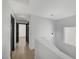 A hallway with neutral colors and modern lighting, leading to various rooms at 6027 Stone Hollow Ave, Las Vegas, NV 89156