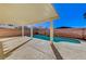 An outdoor pool with a tanning ledge surrounded by a well-maintained patio and block wall at 6027 Stone Hollow Ave, Las Vegas, NV 89156