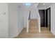 A staircase features light wood and modern railings, ascending to the upper level of the home at 6027 Stone Hollow Ave, Las Vegas, NV 89156