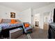 Bedroom with gray chair, king-size bed, and en-suite bathroom at 6101 Cavalry Trl, Pahrump, NV 89060