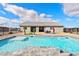 Relaxing pool with stone coping and patio furniture at 6101 Cavalry Trl, Pahrump, NV 89060