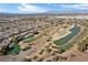 Picturesque aerial view of a golf course community featuring a network of ponds and green spaces at 6151 Moonlight Sonata Ave, Las Vegas, NV 89122