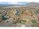 Expansive aerial view of a golf course community with mature trees and serene water features at 6151 Moonlight Sonata Ave, Las Vegas, NV 89122