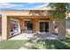 View of the covered back patio with turf and stone pavers at 6151 Moonlight Sonata Ave, Las Vegas, NV 89122