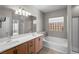 Bathroom featuring double sink vanity, soaking tub, and glass shower at 6151 Moonlight Sonata Ave, Las Vegas, NV 89122