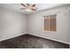 Inviting bedroom with dark wood flooring, neutral walls, and a modern ceiling fan at 6151 Moonlight Sonata Ave, Las Vegas, NV 89122