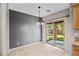 A dining area with tile flooring and a sliding glass door leading to the backyard at 6151 Moonlight Sonata Ave, Las Vegas, NV 89122